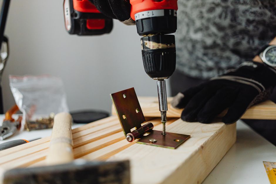 Carpenter measuring and installing a new door